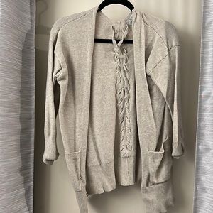 Beige sweater with braid in back. Size large